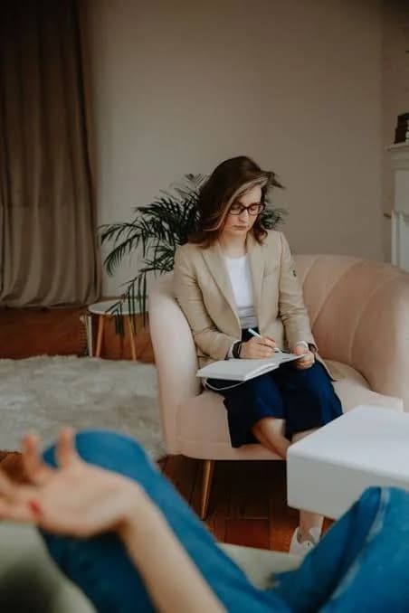 A consultant taking notes during a client meeting